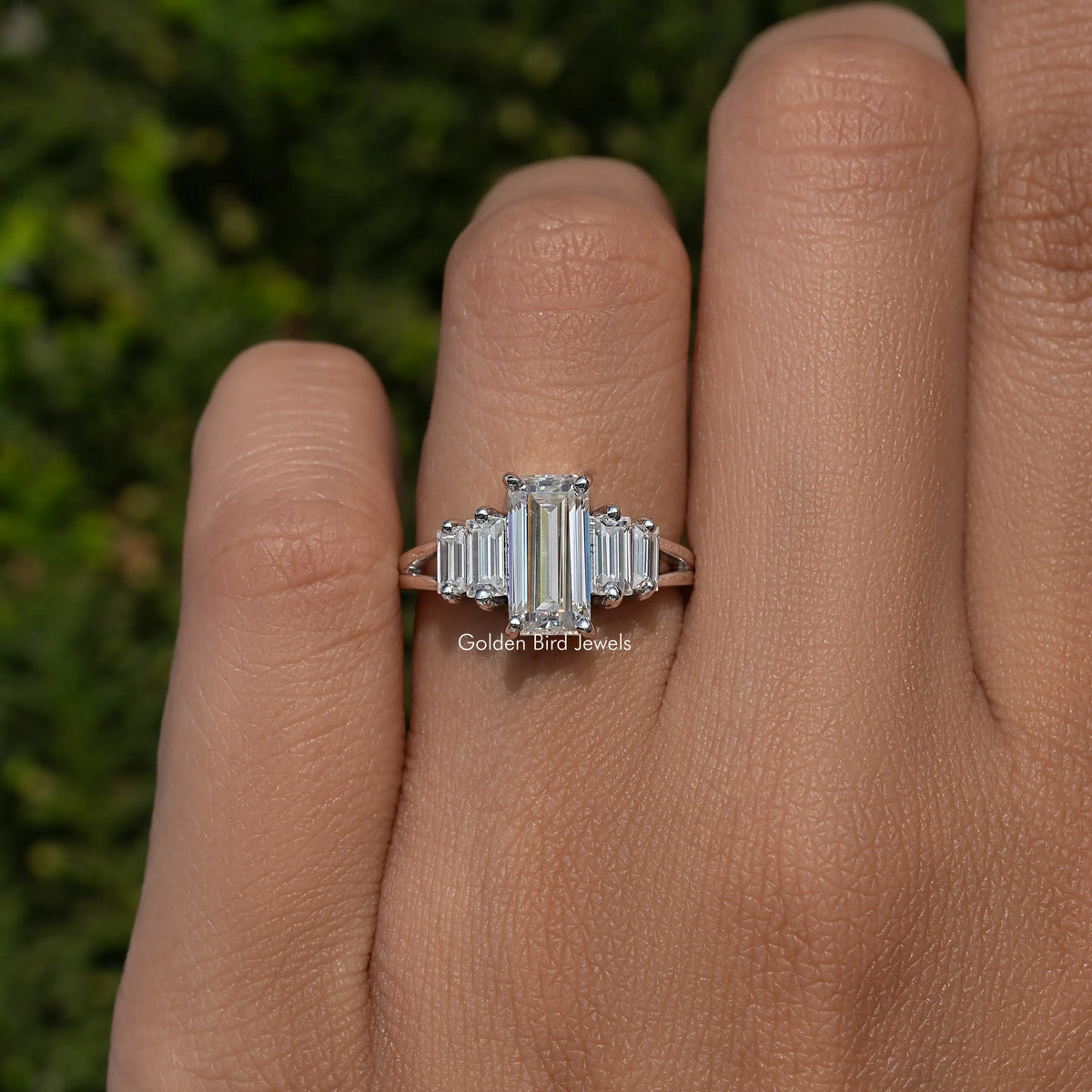 Five-stone split shank ring close-up with rectangular emerald-cut stones, silver tone