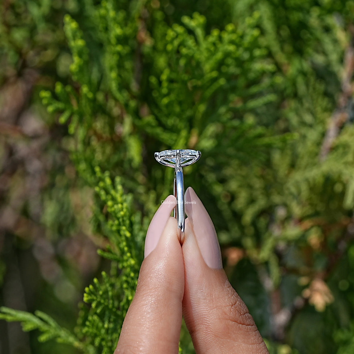 Side View of Marquise Cut Solitare Ring in two fingers