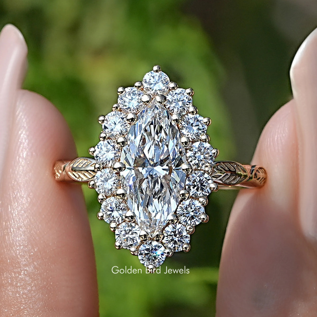 Marquise Cut Lab Diamond Halo Engagement Ring Held Between Fingers
