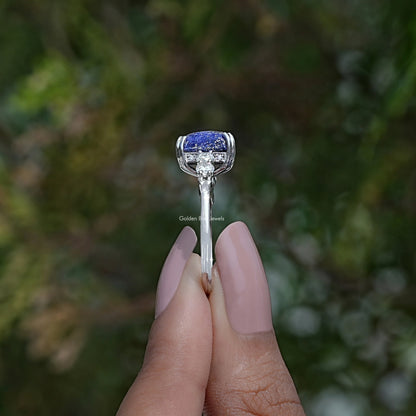 Side View of Emerald Cut Hidden Halo Accent Stone Ring In two fingers