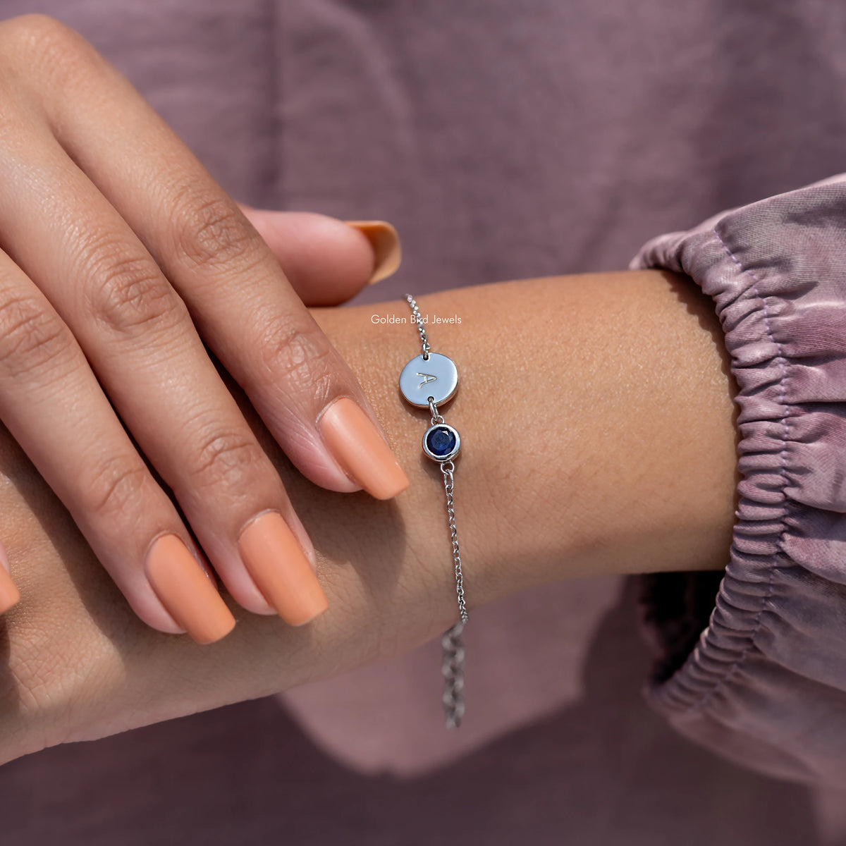 Sterling silver bracelet with A disc and blue round gemstone, hand-adjusting