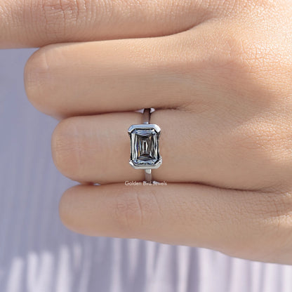 Close-up of sterling silver east-west moissanite solitaire ring with half bezel square stone