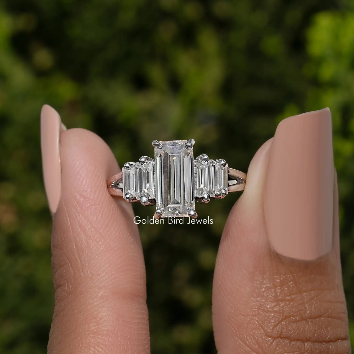 Five-stone split shank ring with rectangular emerald-cut stones, silver tone