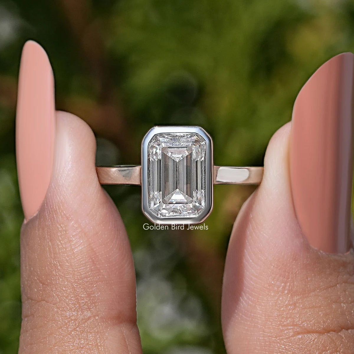 Emerald-cut moissanite solitaire ring, bezel-set center with slim band—side view