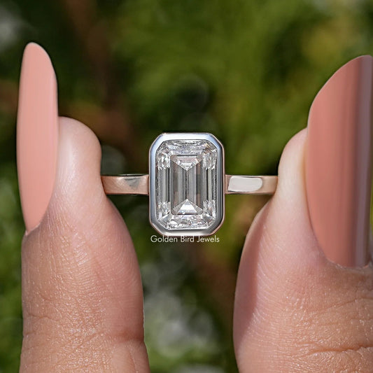 Emerald-cut moissanite solitaire ring, bezel-set center with slim band—side view
