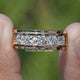 Round Cut Lab Diamond Channel Set Men’s Ring Held Between Fingers