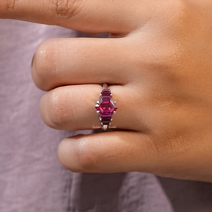 Ruby red hexagon-cut center gemstone with four side stones on slim silver ring band