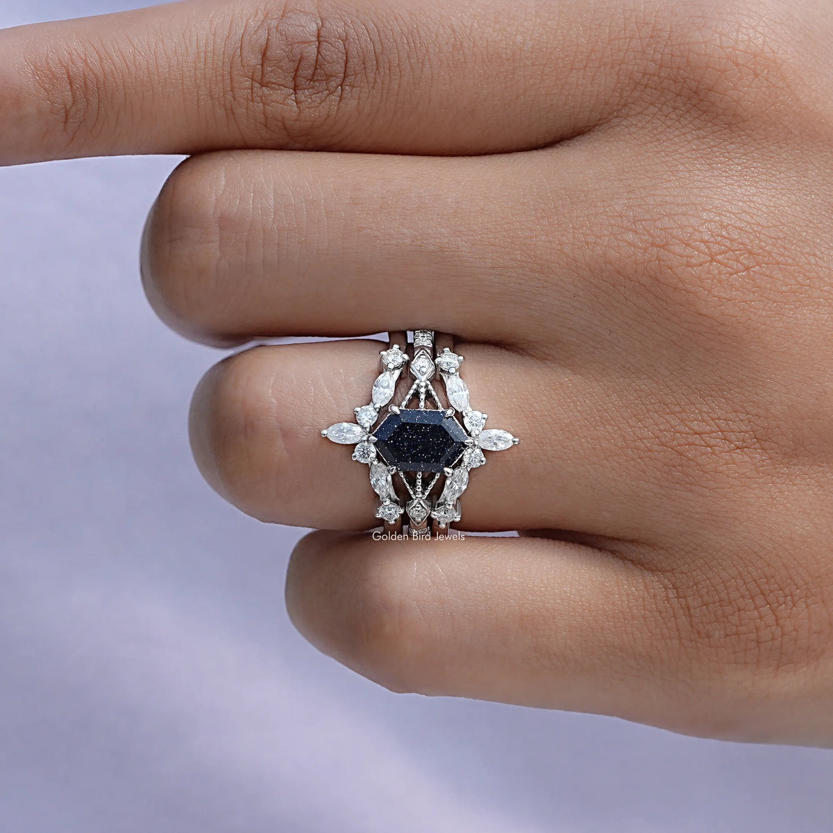 Sterling ring with dark blue center and white marquise stone halo, close-up