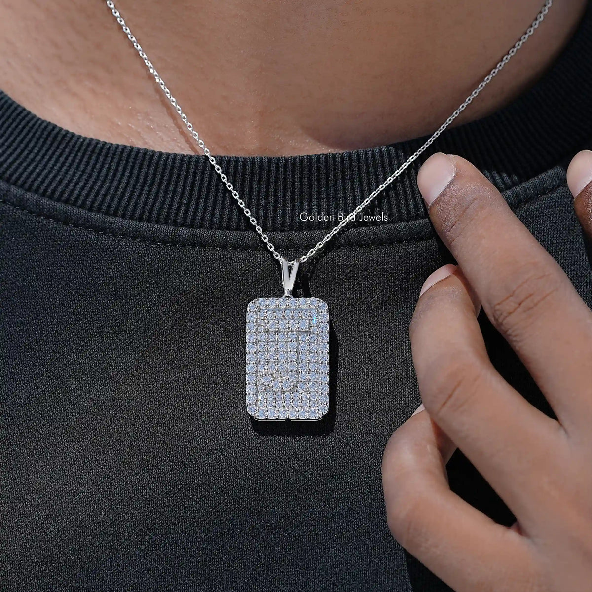 Square lab diamond pendant on silver chain, close-up on neckline