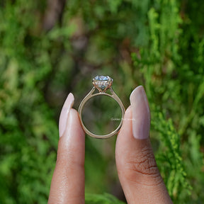 Back View of Cushion Cut Diamond Halo Engagement Ring In two fingers