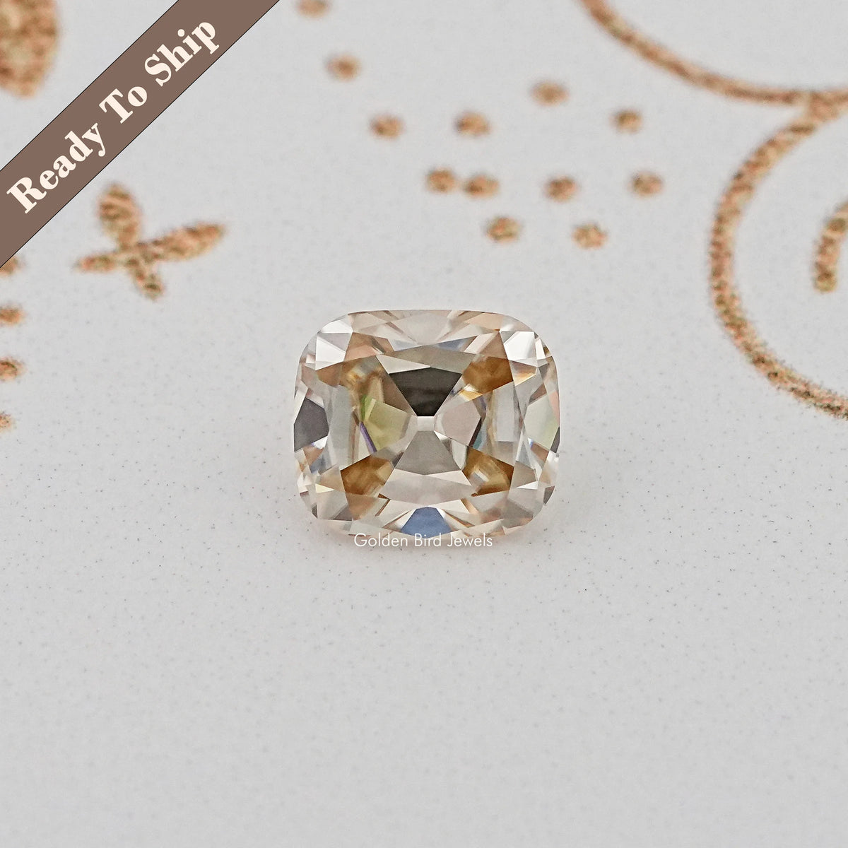 Cushion-cut loose gemstone with golden tones, faceted