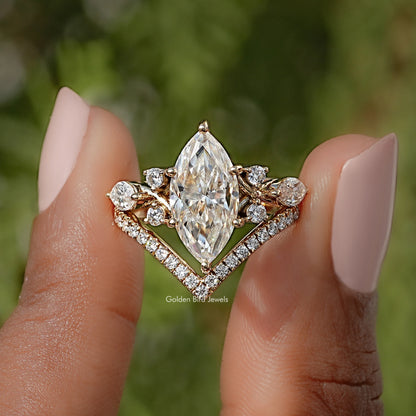 Gold-tone marquise cut engagement ring with large center stone and side halos