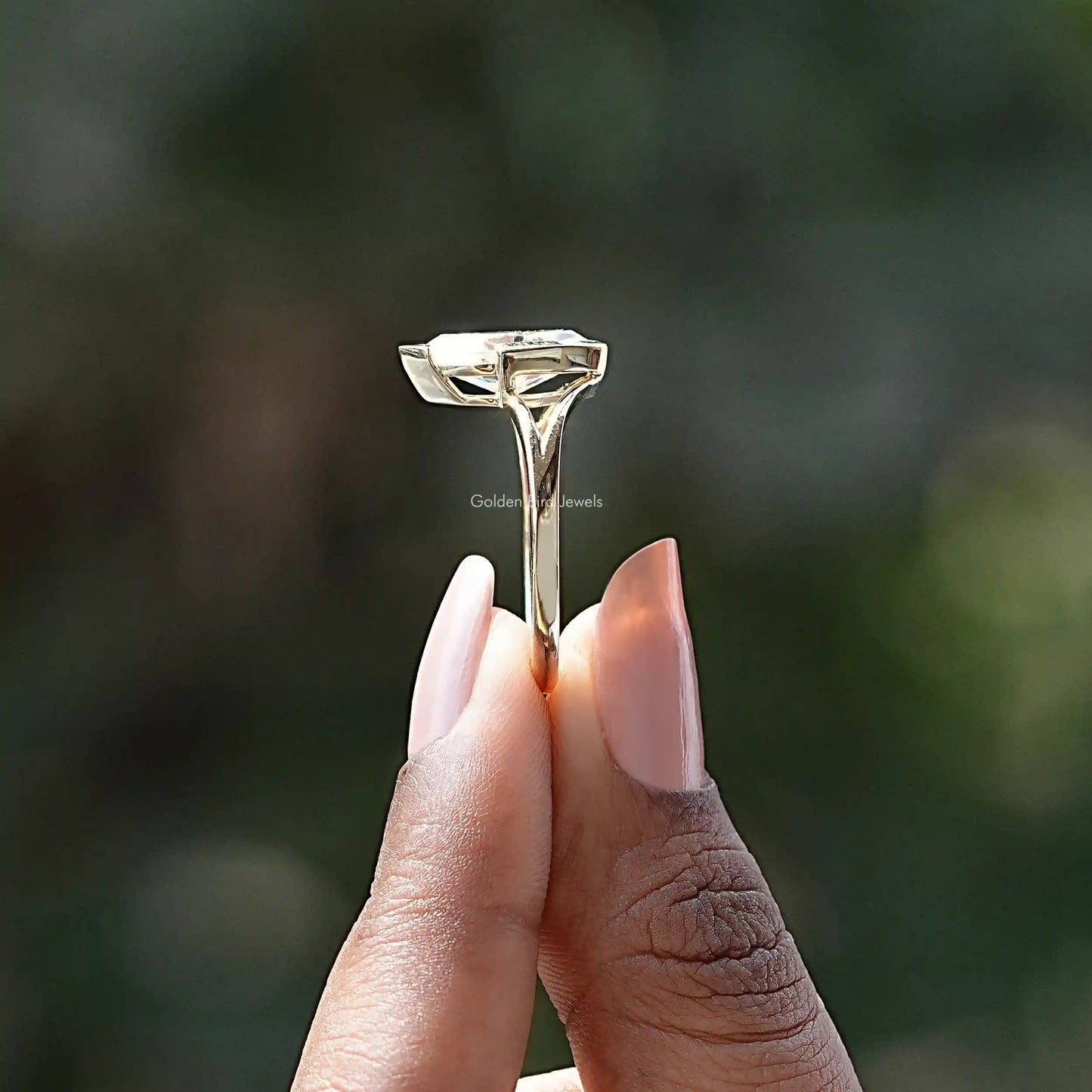Side View of Moissanite Marquise Cut Solitaire Ring In two fingers