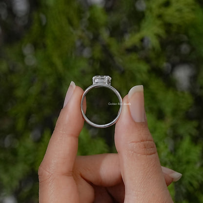 Sterling silver ring shown from the side, with a raised oval stone setting and curved band