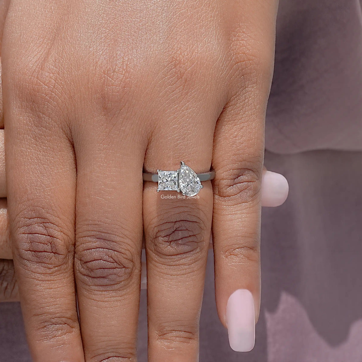 Toi et moi moissanite ring with pear and princess stones on a white metal band