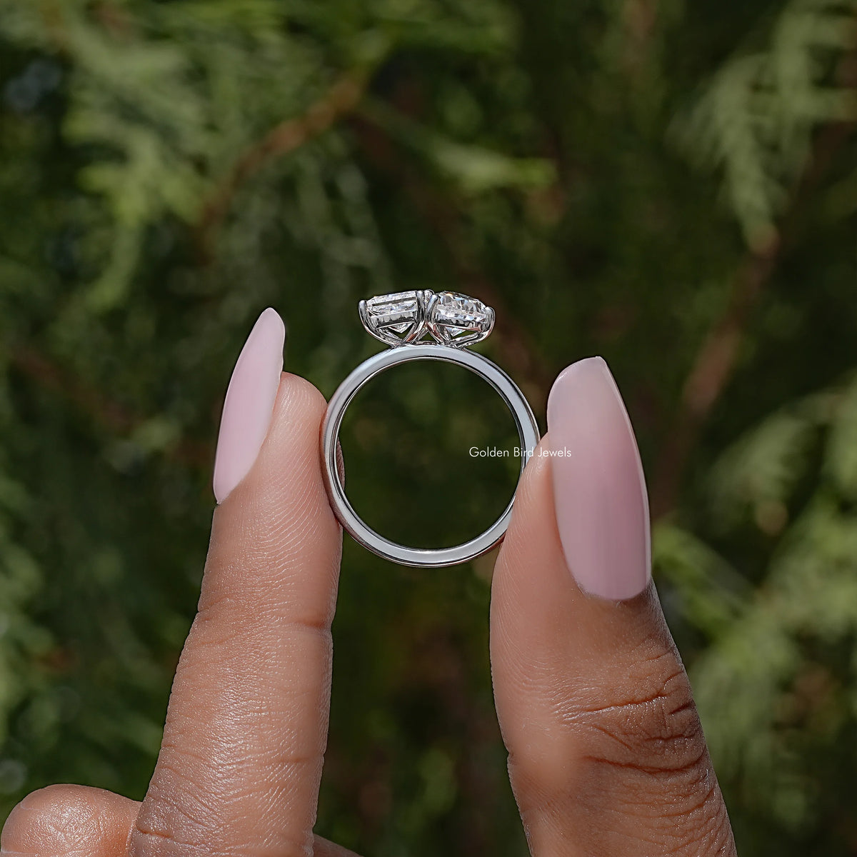 Toi et moi moissanite ring showing pear and princess cut stones in a prong setting