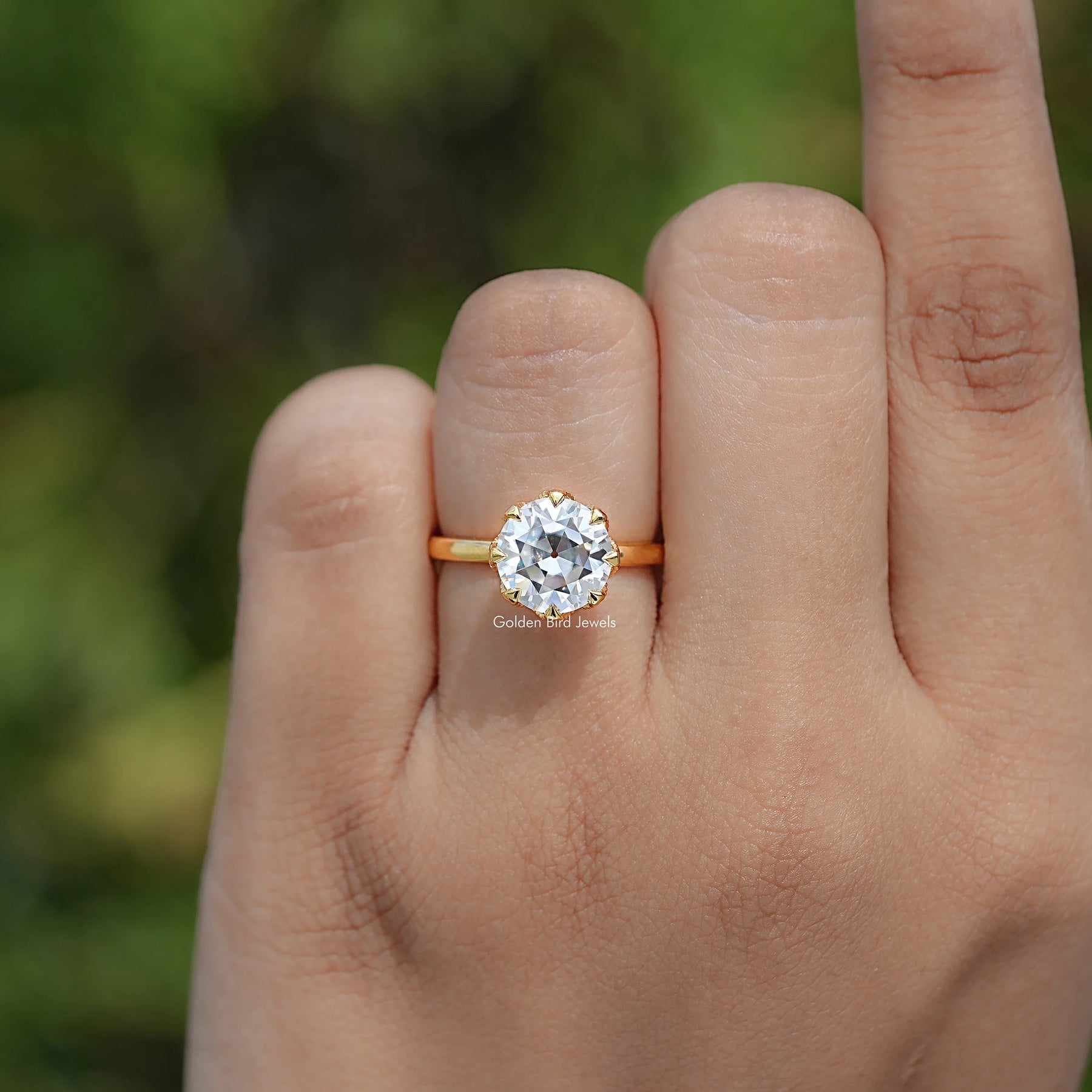 In finger view of Round Cut Solitaire Engagement Ring