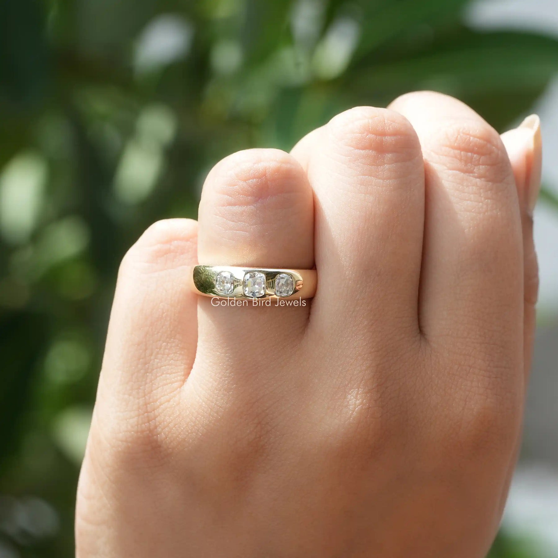 In hand showing a view of moissanite Ring	 		