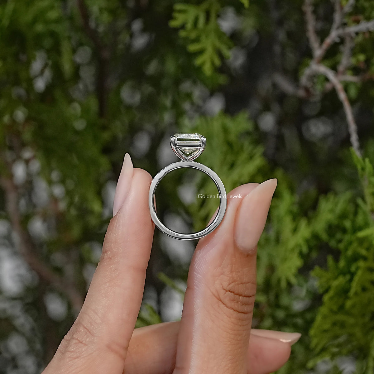 Sterling silver solitaire ring shown from the side, with a raised rectangular center stone and smooth band