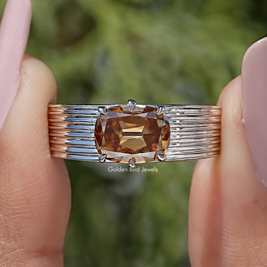 Rose gold cushion-cut gemstone band with east-west prong setting and ridged shoulders