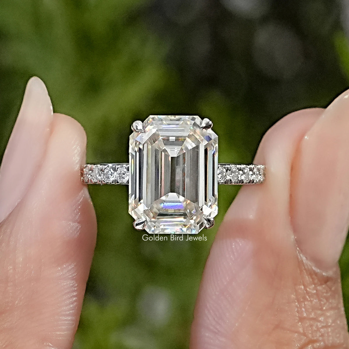 Emerald cut moissanite ring with hidden halo and pavé silver band