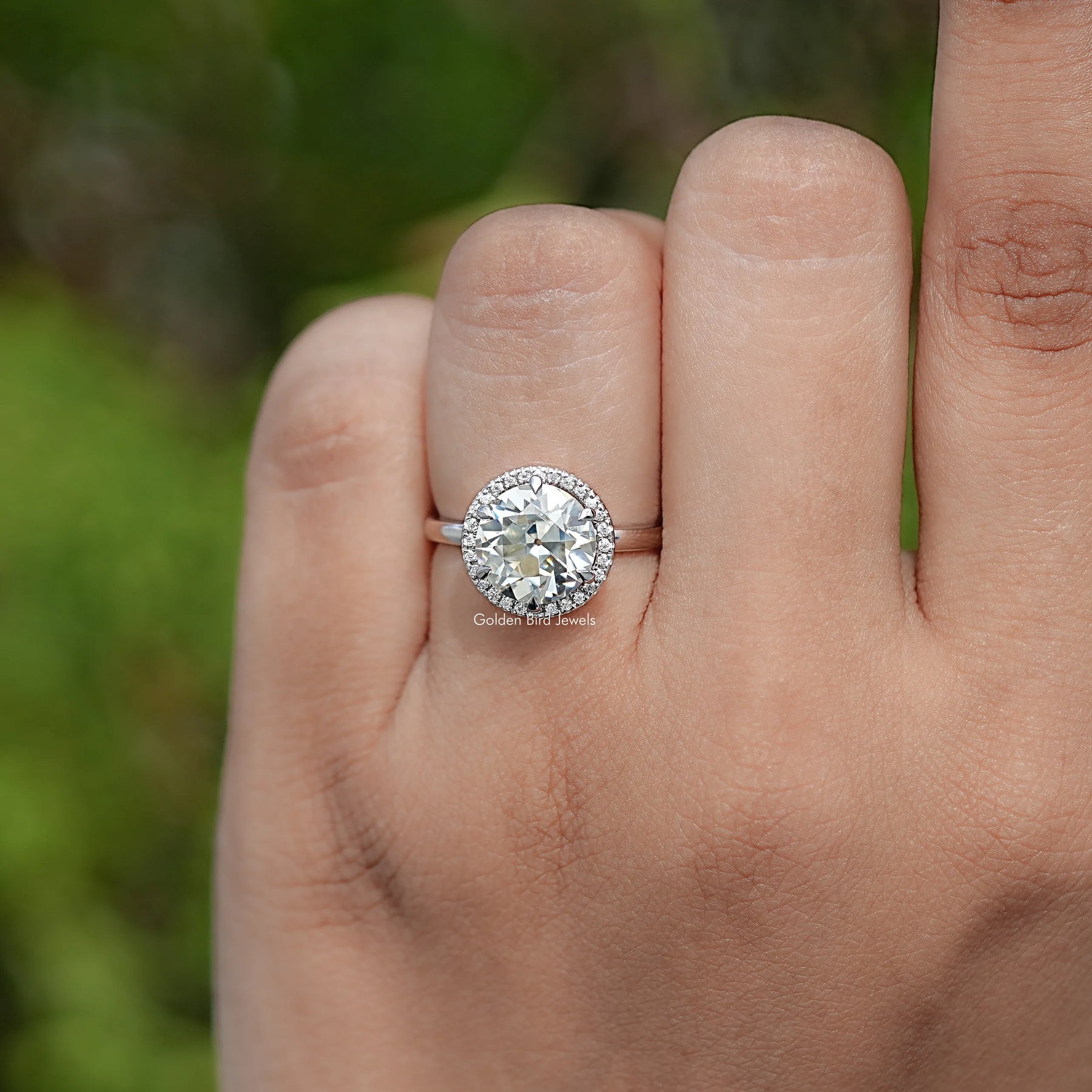 In finger view of Round Cut Moissanite Engagement Ring
