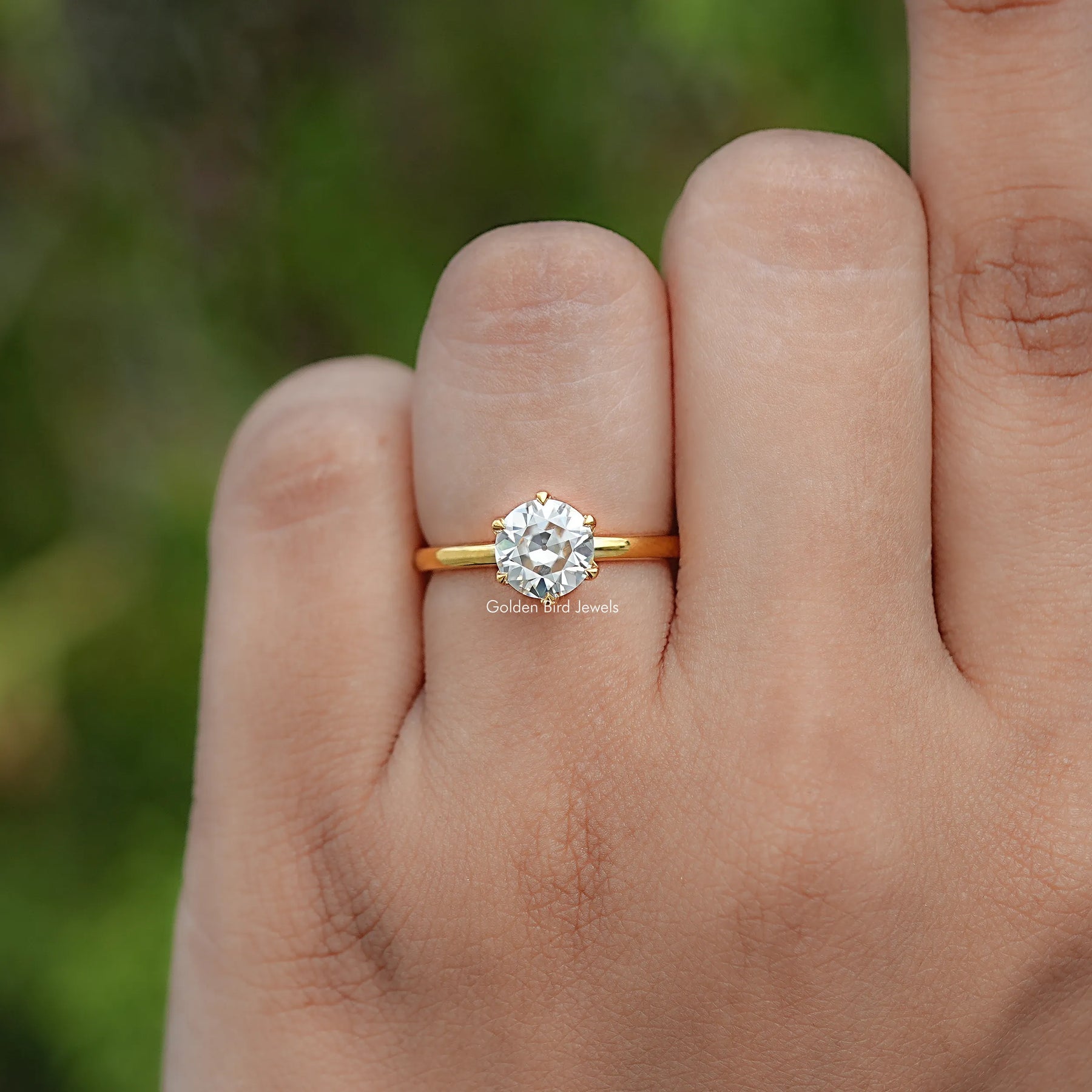 In finger view of Round Cut Moissanite Engagement Ring