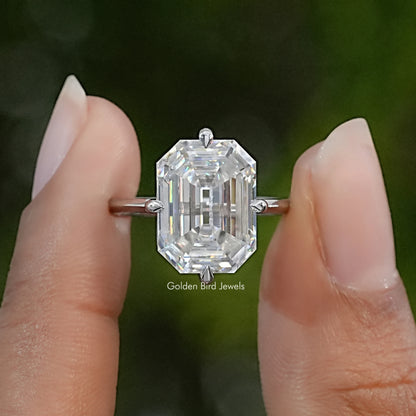 Emerald-cut moissanite engagement ring in sterling silver, shown from above with a clear rectangular center stone.