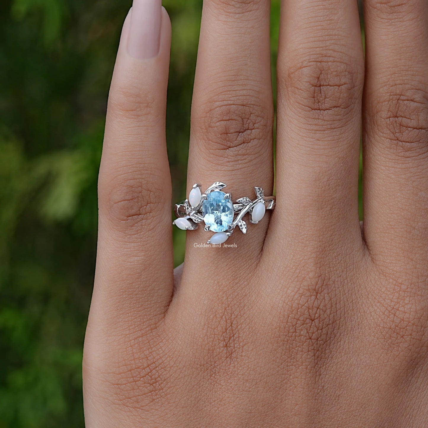 Detailed View Of Oval Cut Gemstone Leaf Style Accent Ring In Yellow Gold