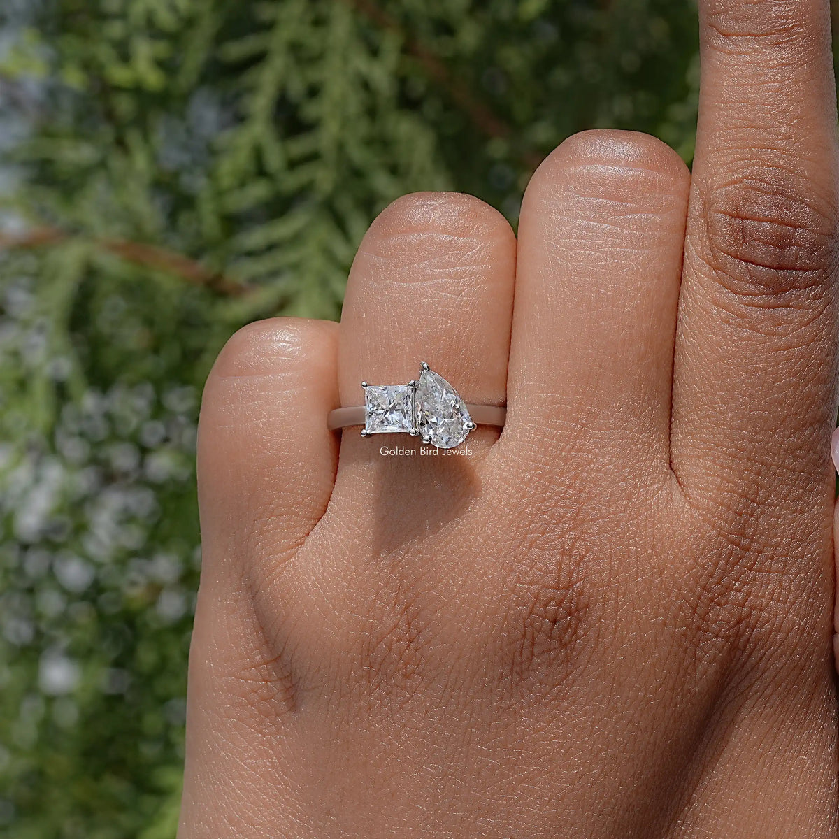 Toi et moi moissanite ring with pear and princess stones on a silver band