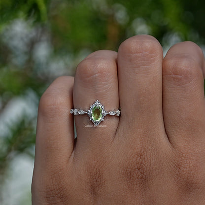 Profile View of Green Oval And Colorless Round Cut Accent Ring