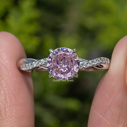 Silver round pink tourmaline ring with halo and small clear side stones