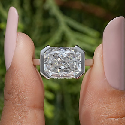 Radiant-cut moissanite solitaire ring with half-bezel setting in silver-tone band