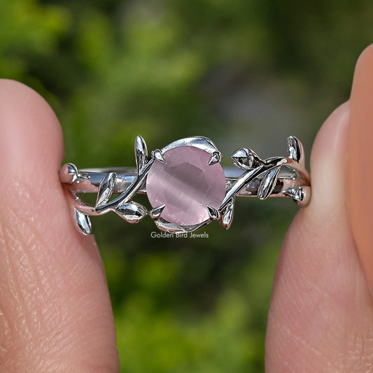 Close-up of rose quartz round gemstone ring with silver-tone leaf prongs