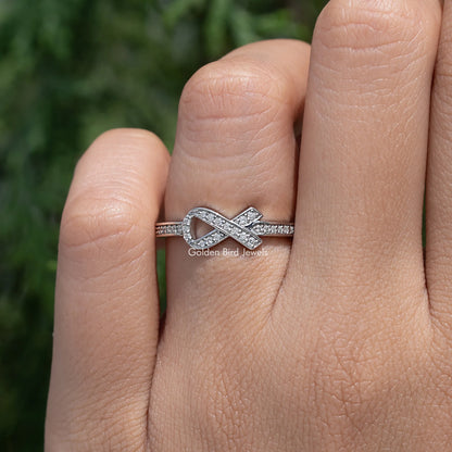 Silver hope ring with round-cut stones across the band, side view on finger
