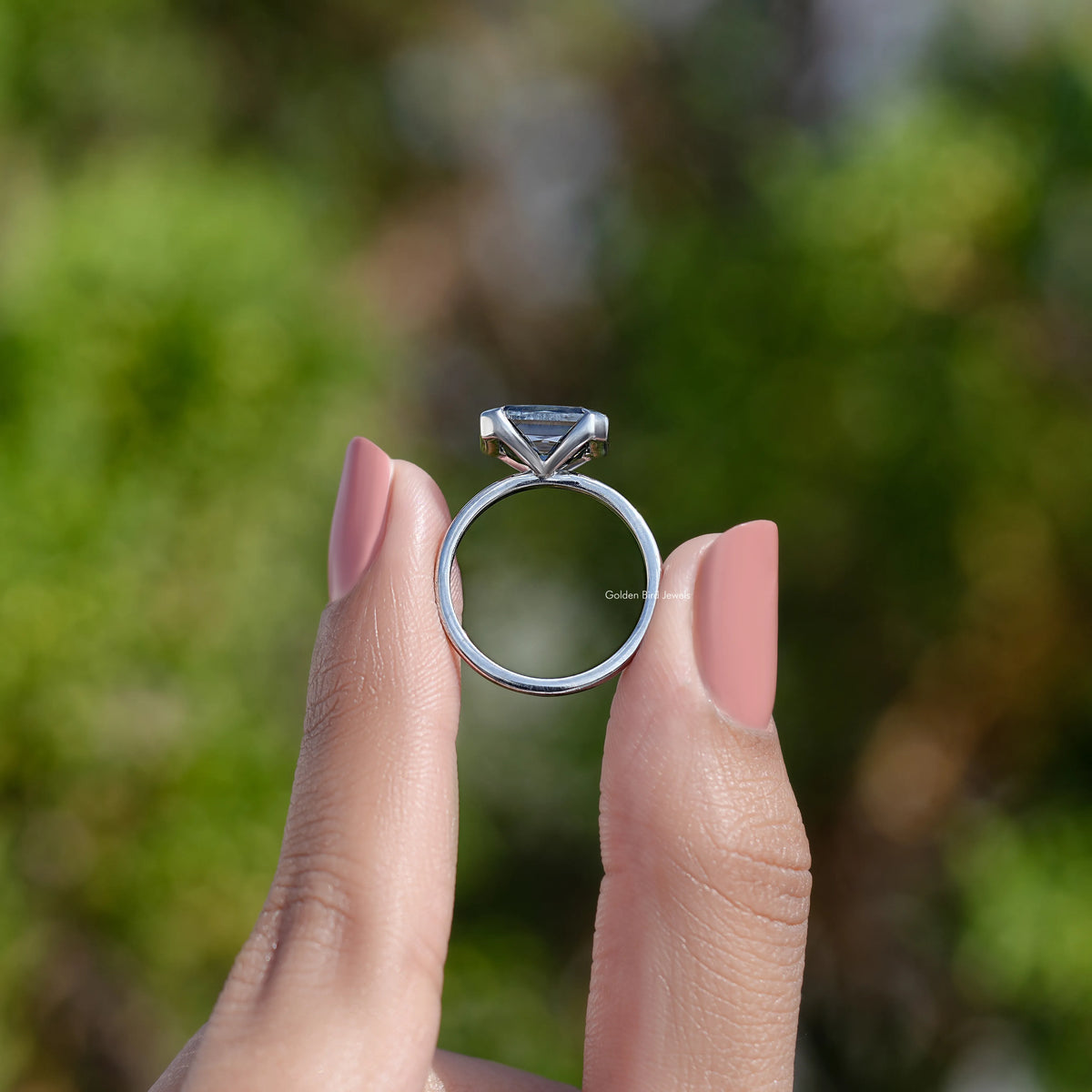 Sterling silver east-west moissanite ring with half bezel solitaire, side profile view