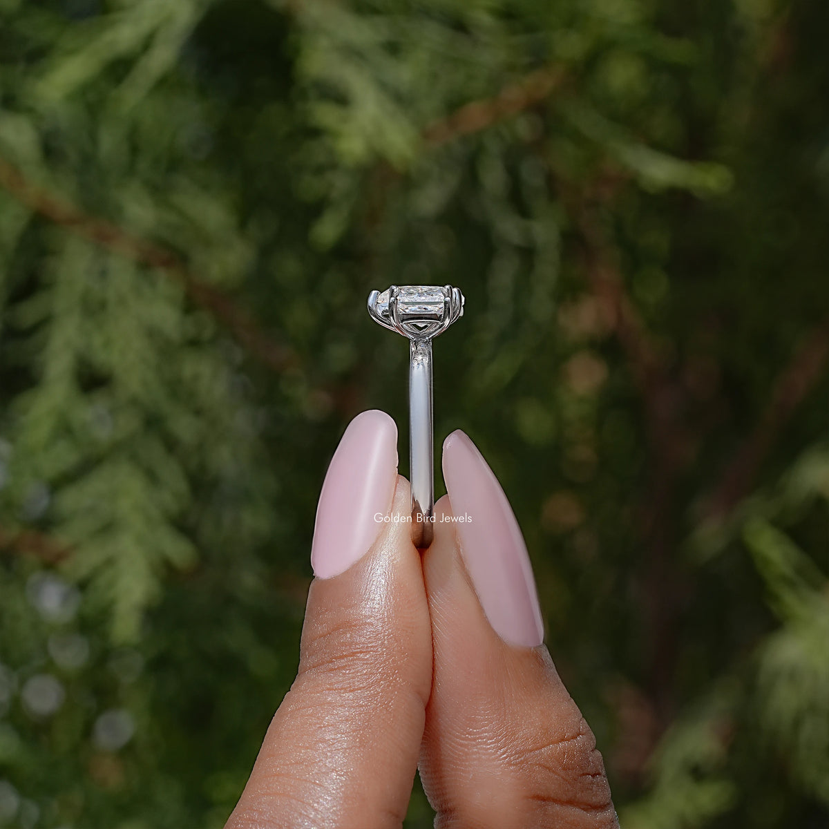 Toi et moi moissanite ring detail with bezel-set pear stone and prong-set top