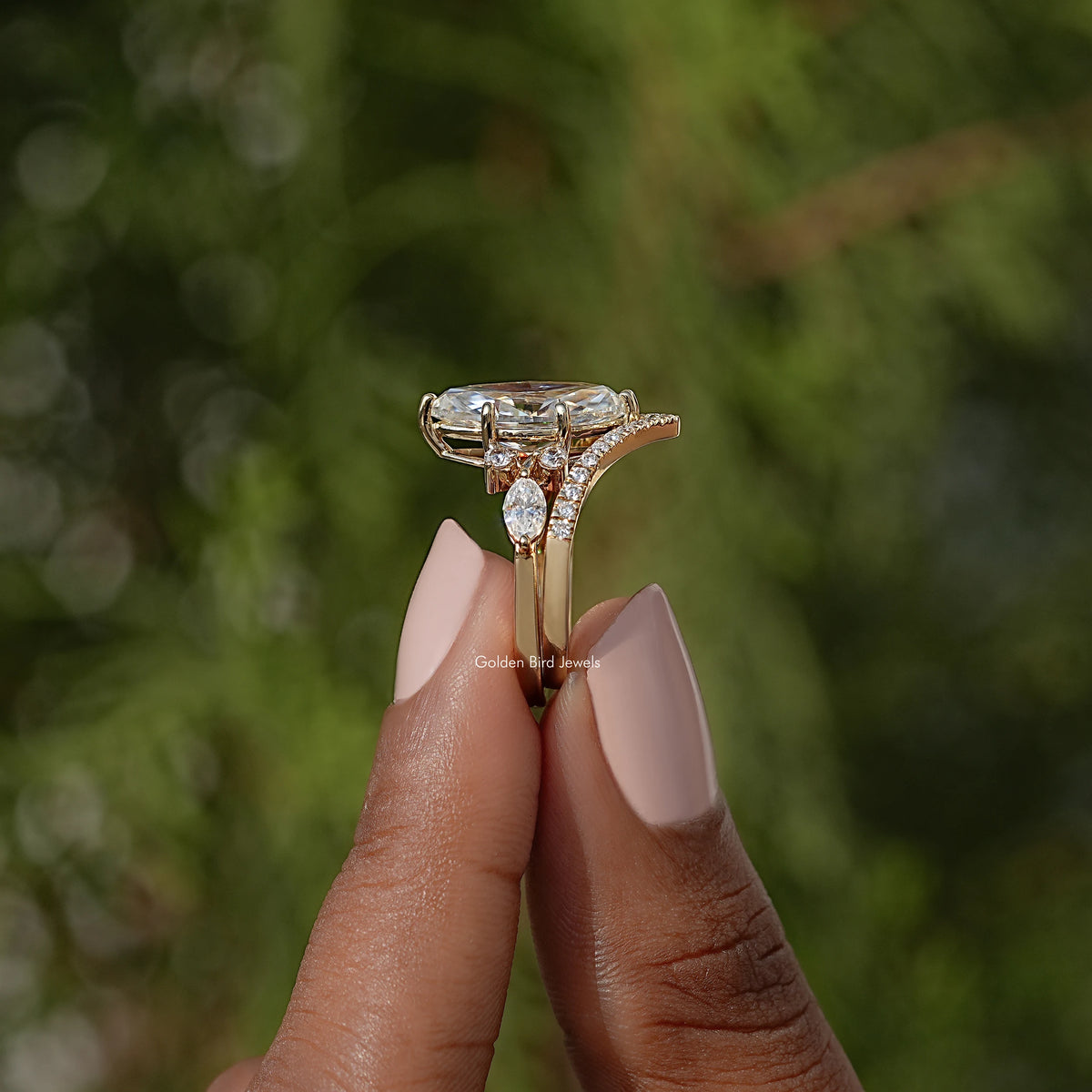 Gold-tone marquise cut ring side profile with small round stone accents