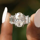 Front view of Crushed Ice Oval And Baguette Cut Moissanite Five Stone Ring in two fingers 