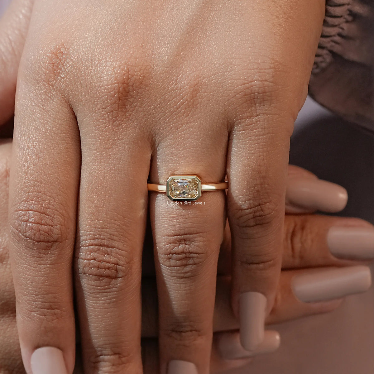 Gold-tone moissanite solitaire engagement ring, bezel-set radiant-cut center