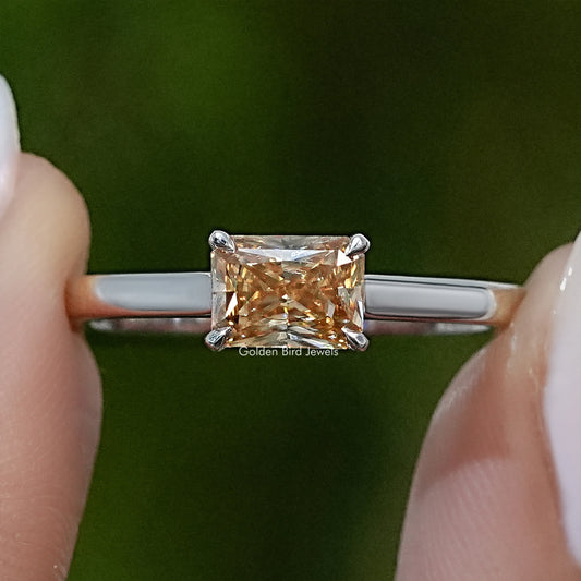 Emerald-cut yellow moissanite solitaire ring on silver-tone band, front view