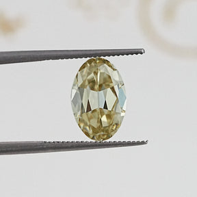 In Tweezer View Of Old Mine Oval Cut Loose Moissanite Stone