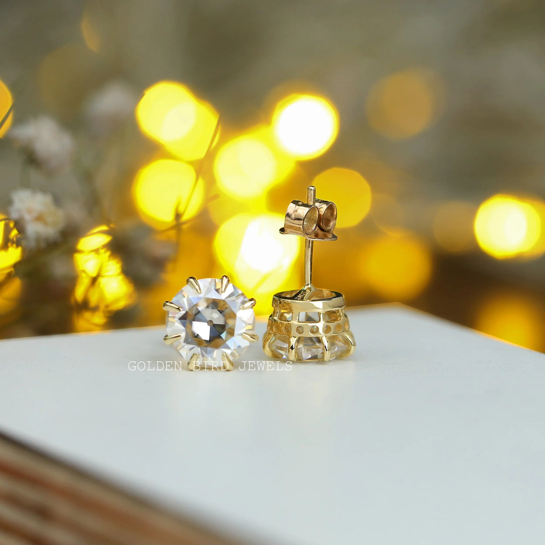 Front and back view of round cut solitaire earings 